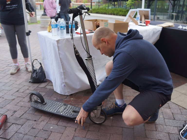 man fixing a scooter