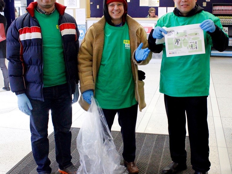 three volunteers posing while wearing rubber gloves