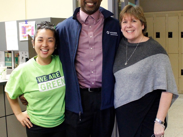 Wanda Buote posing with a volunteer and a faculty member