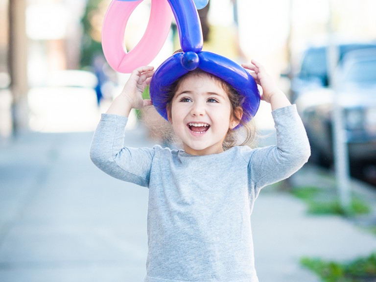Child wearing a balloon hat
