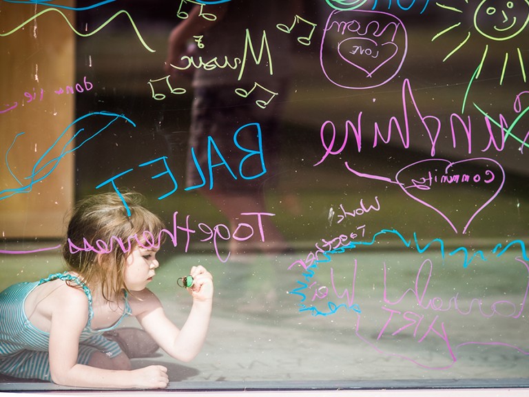 Child drawing on glass