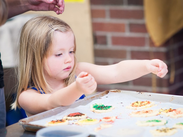 Young girl decorating cookies
