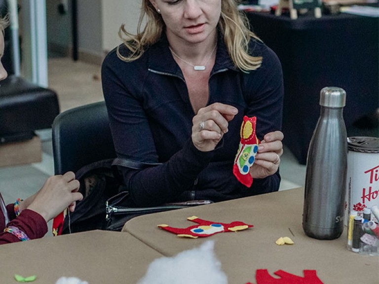 woman holding a stitched toy