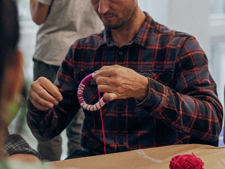 man wrapping with thread