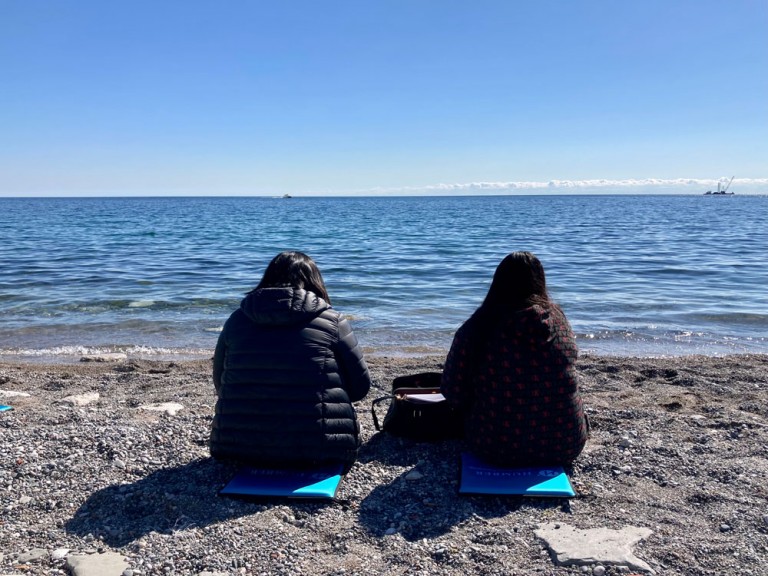 Two Students sitting on the beach