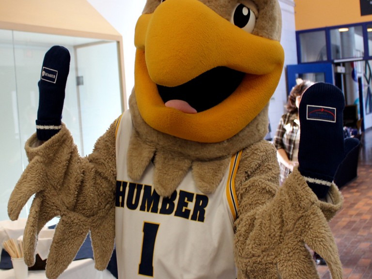 humber hawk mascot wearing mittens