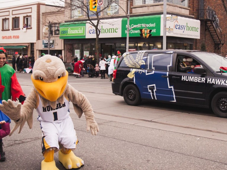humber hawk mascot walking in the parade in front of the humber car