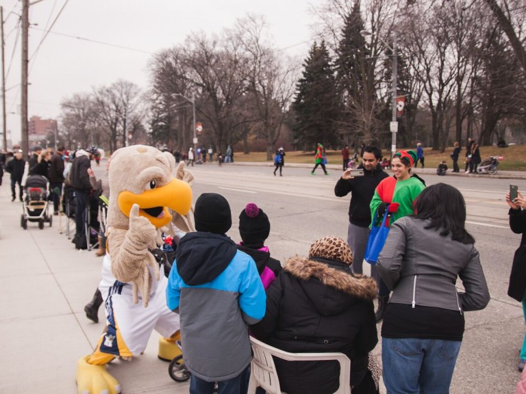 humber hawk mascot posing for a photo with people in the crowd
