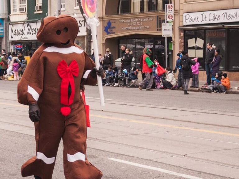 person in a gingerbread man costume walking in the parade
