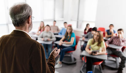 man talking to a group of students