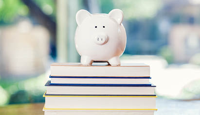 piggybank on top of books
