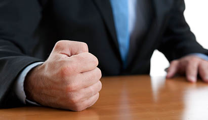 man clinching fist on the table