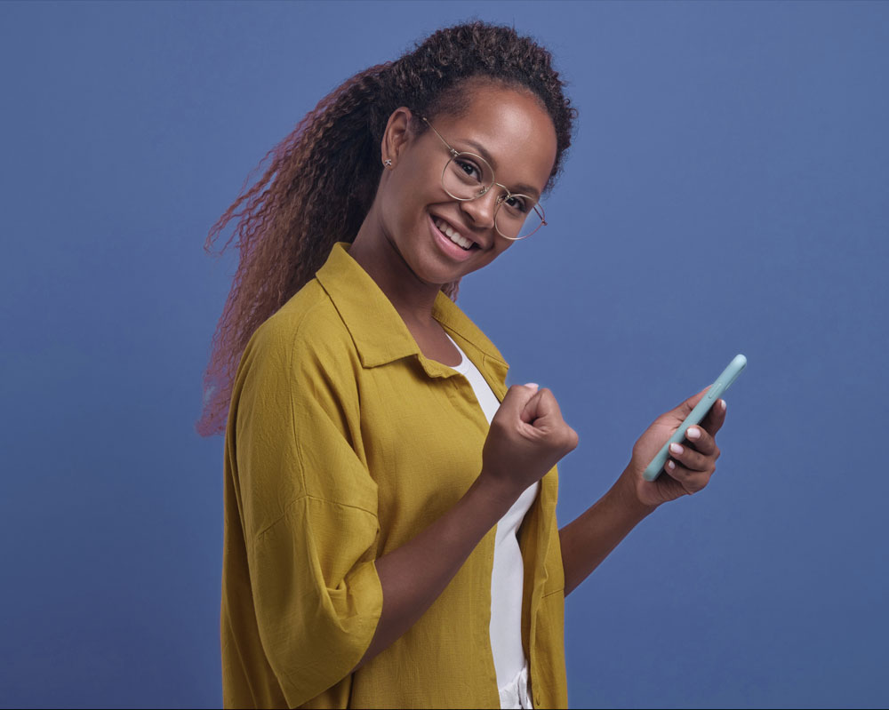 Person holding cell phone pumping fist