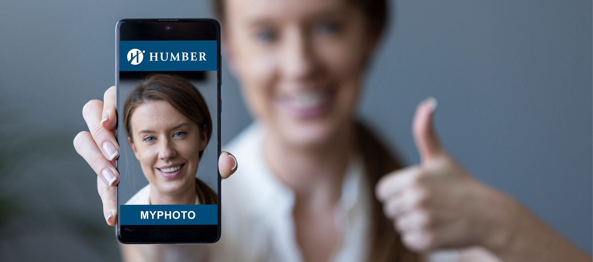Person holding up phone displaying their photo