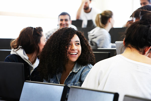 employees gathered around smiling in office