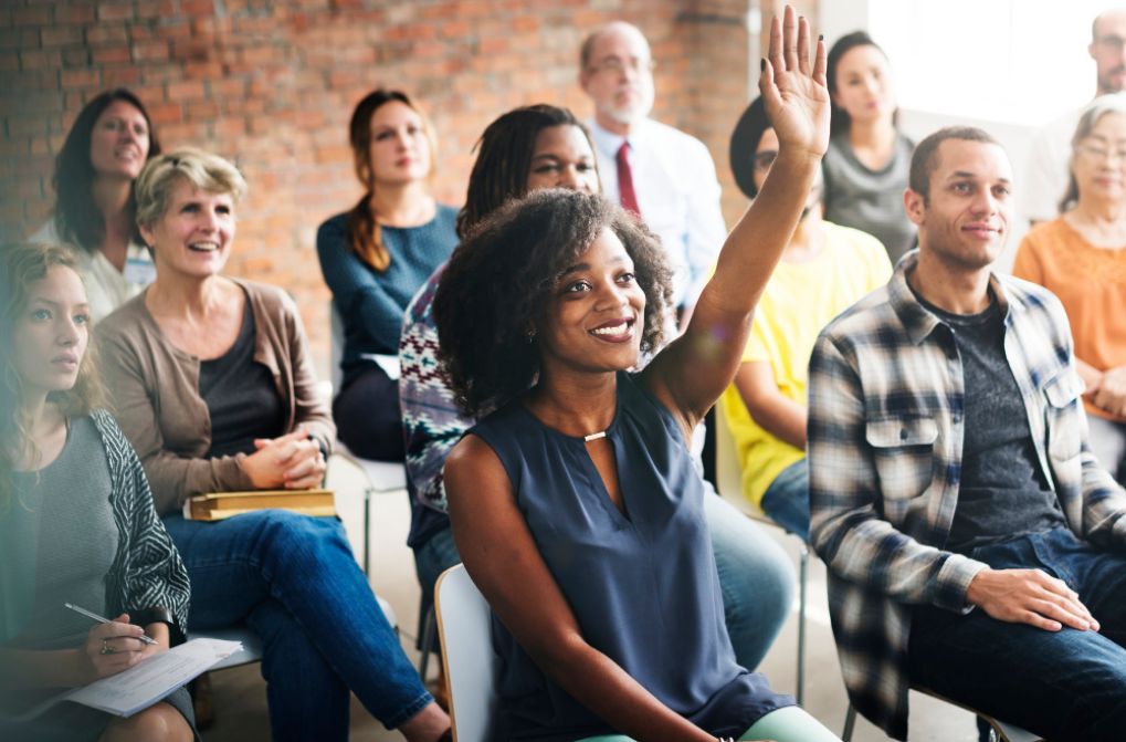 employees gathered around smiling in office