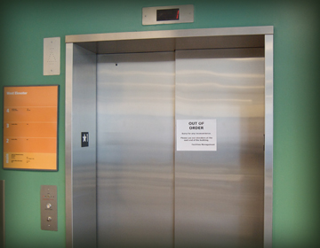 closed elevator doors with out of order sign on them