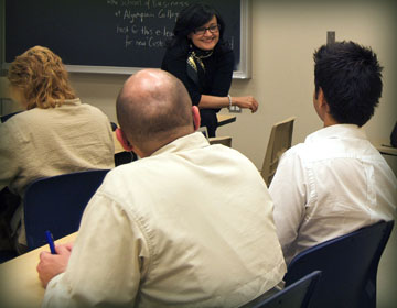 Instructor in classroom smiling at students