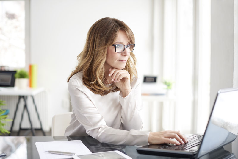 smiling woman working at computer