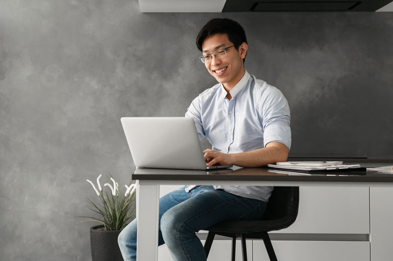 smiling student working on laptop