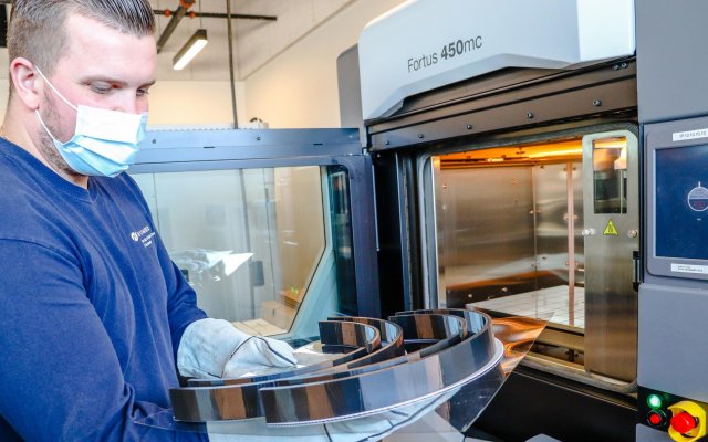 Person in mask working with machinery