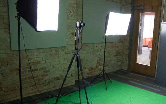 Room with green screen and lights for media production