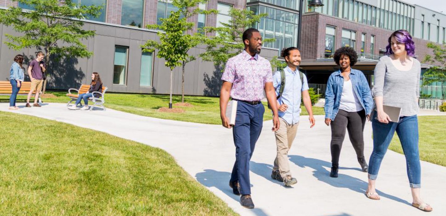 4 students walking on campus