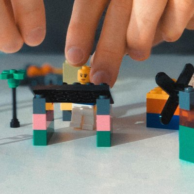 Person building Lego structure for coding. Photo by Sebastien Bonneval on Unsplash.