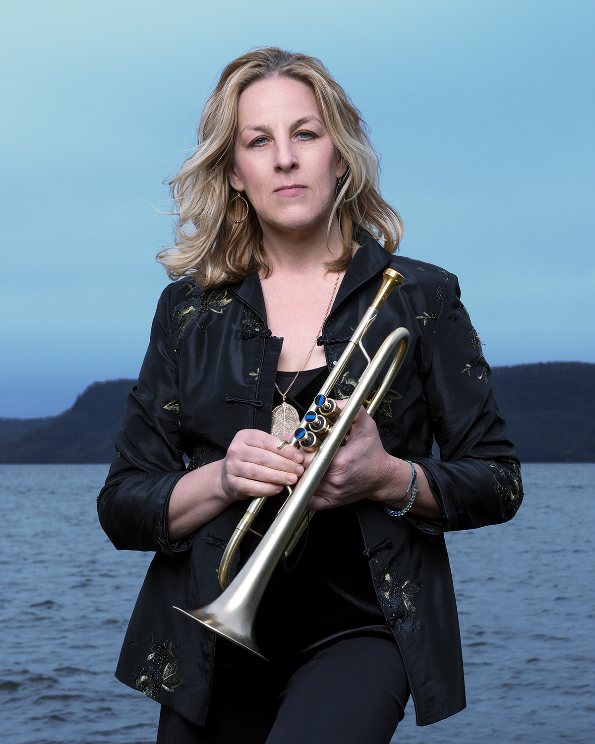 Ingrid Jensen holding a trumpet