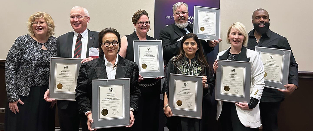 Eight individuals including Humber's seven Premier's Awards nominees and Humber President and CEO Ann Marie Vaughan posing for a photo holding plaques.  