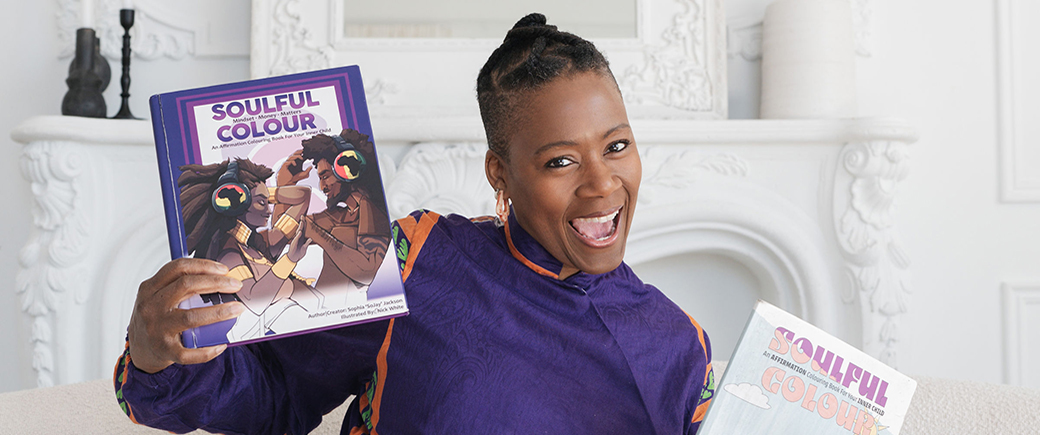 Humber alumna Sophia Jackson holding copies of her Soulful Colour books