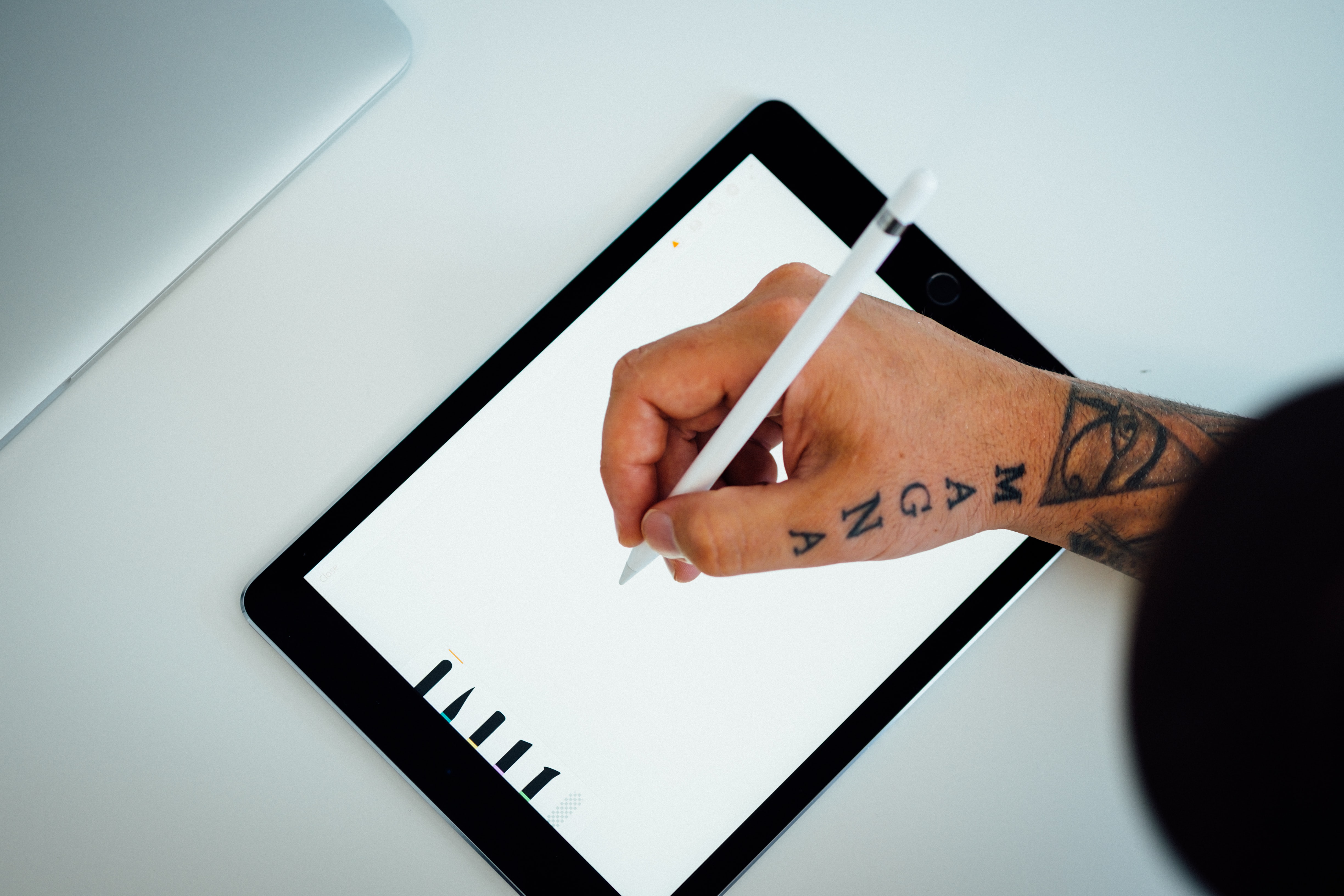 Person digitally drawing on a tablet.