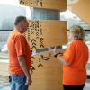 Jason Seright and Ann Marie Vaughan engage in a conversation while wearing orange shirts for Orange Shirt Day.
