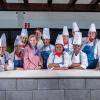 A group of people, most of whom are wearing chef uniforms, pose for a photo.