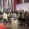 A group of people stand together in a studio.