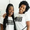 Two smiling people wearing shirts that reads Natural Kids Movement.