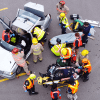 An overhead photo of students rescuing mock patients from a vehicle as part of a simulated mass casualty event.