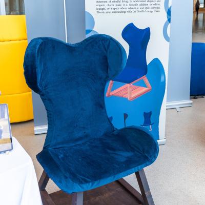 A blue chair without arms that has a high back.