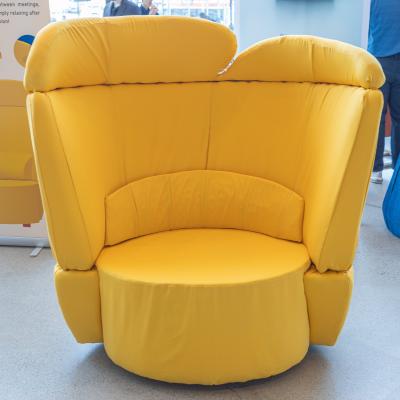 A yellow chair with a high back.