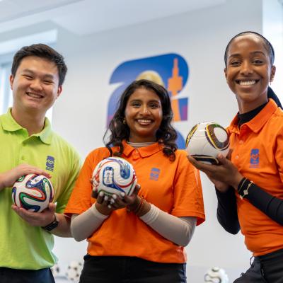 Humber students and volunteers in the volunteer centre. Humber student and volunteers pose with mini soccer balls.