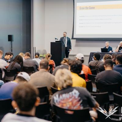 Crowd watches a presentation on a screen