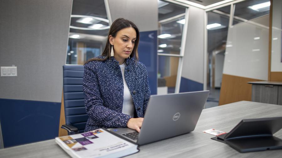 A person is sitting down and working on a computer.