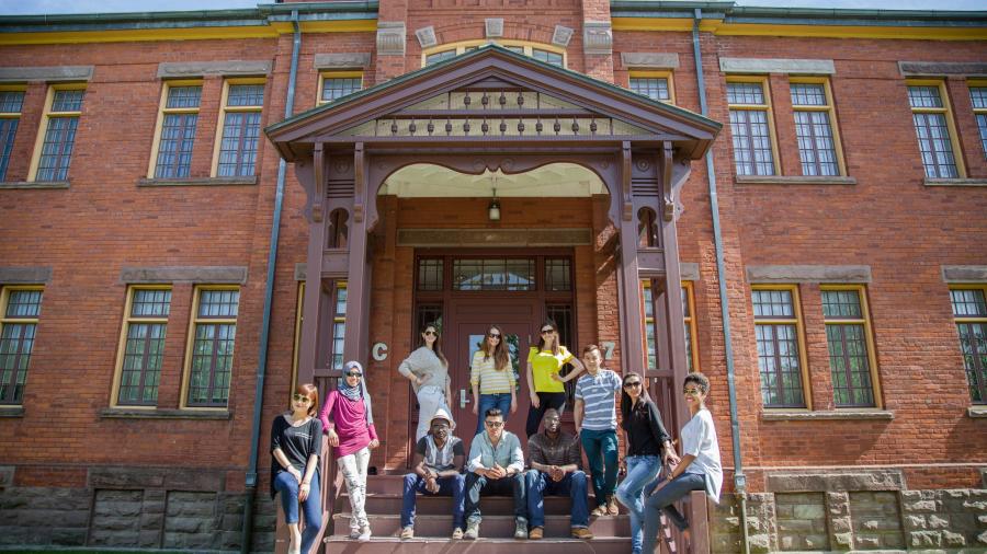 A group of students gather on the stairs of a historic building at Humber College's Lakeshore Campus