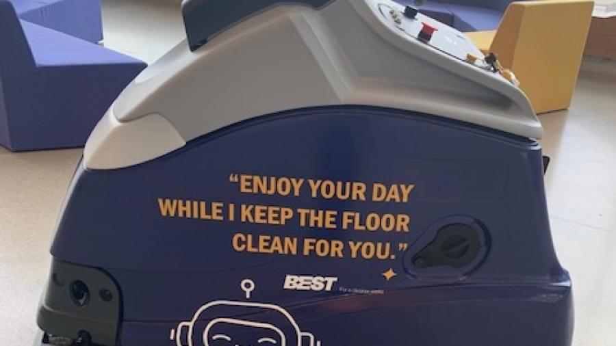A cleaning machine with the Humber College logo with the words Enjoy your day while I keep the floor clean for you on the side.