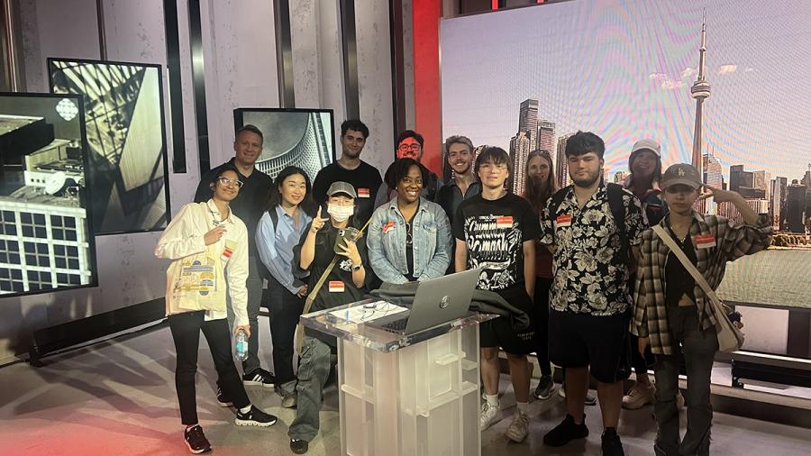 A group of people stand together in a studio.