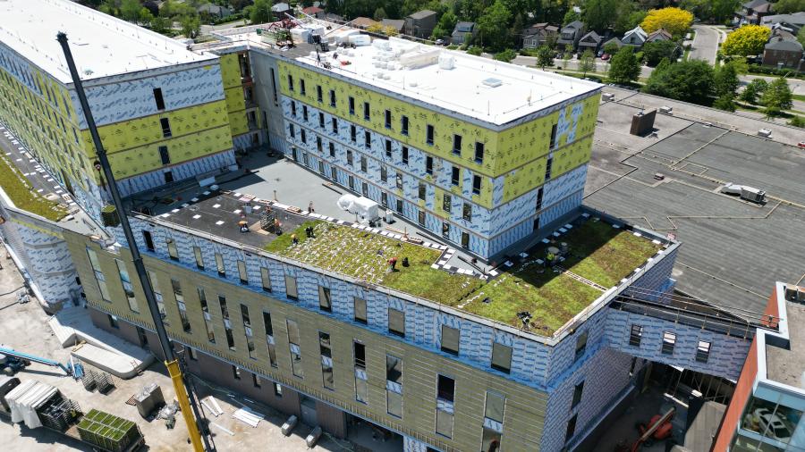 A building that is under construction. A green roof is visible.