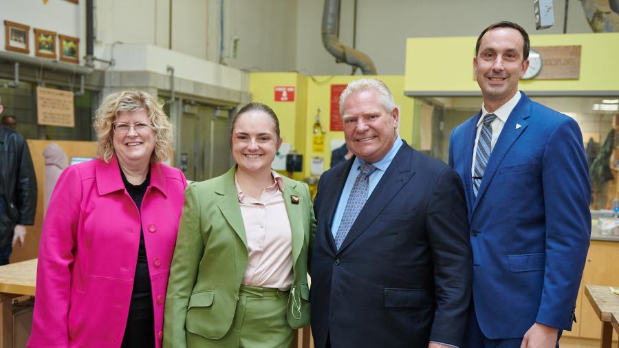 Four smiling people stand together in a learning lab at Humber Polytechnic’s Centre for Skilled Trades and Technology.