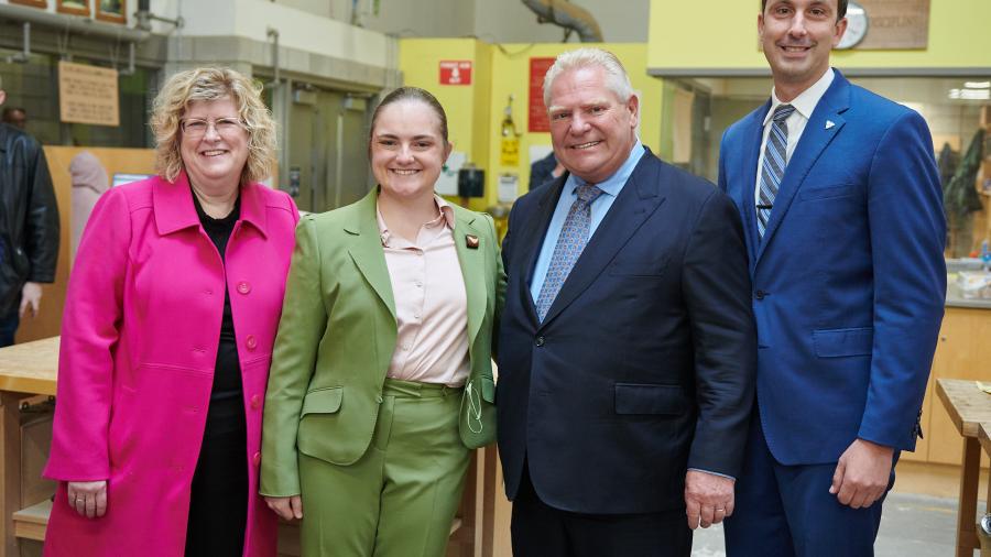 Four smiling people stand together in a learning lab at Humber Polytechnic’s Centre for Skilled Trades and Technology.