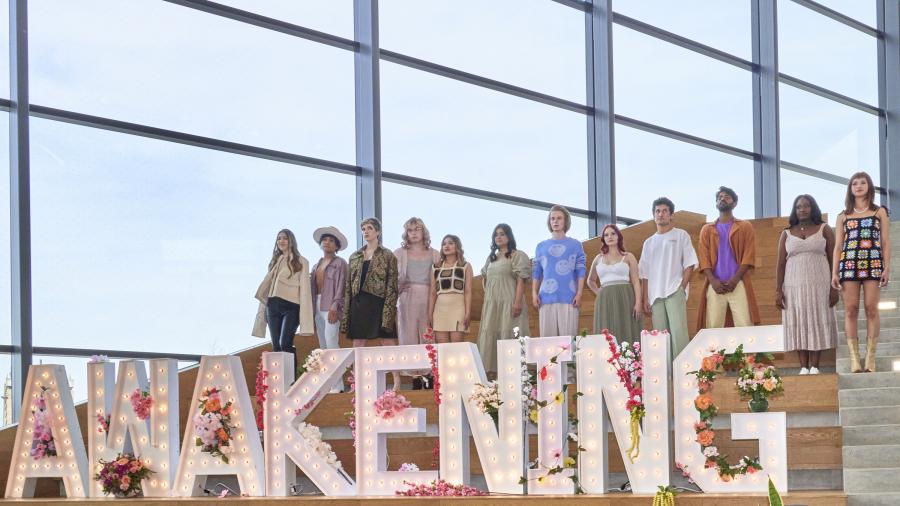 A group of models stand behind a sign reading "Awakening" at the Humber College Fashion Show