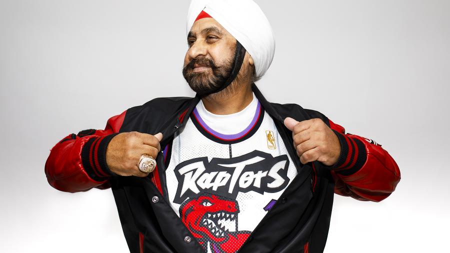A person wearing a Toronto Raptors jersey underneath their jacket.